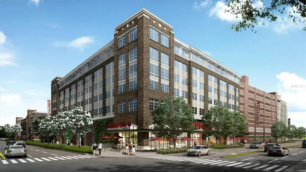 a view of a tall building next to a road