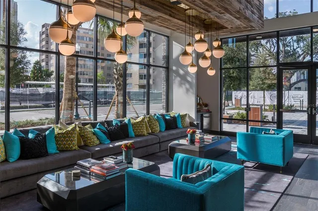 a living room with furniture and a floor to ceiling window