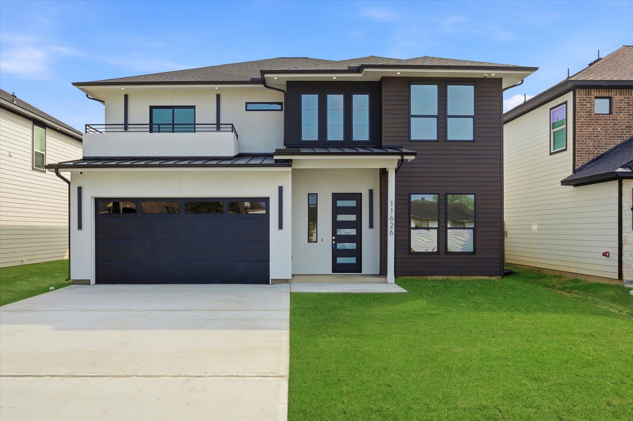a front view of a house with a yard and garage