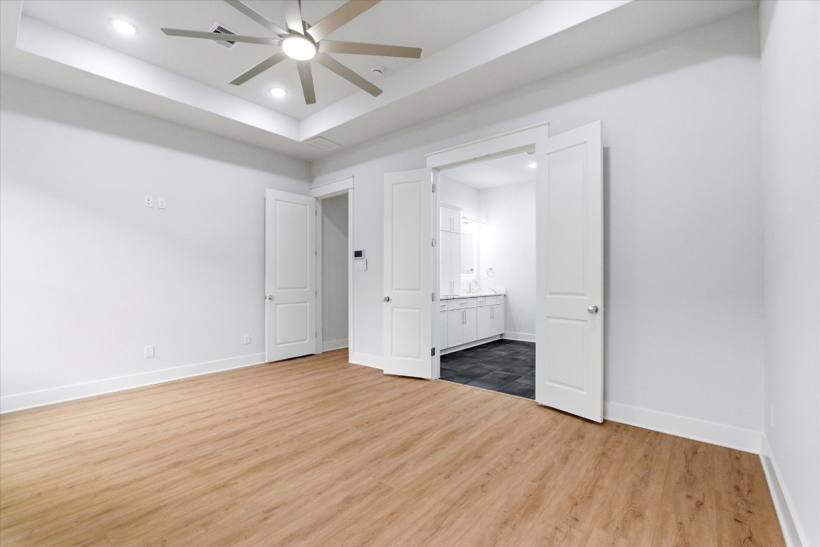 11626 Flintlock Road La Porte, TX 77571 - Photo 11 of 26 The primary bedroom showcases recessed lighting and 11 foot ceilings, a built in security system control panel and double doors that open directly into your private en-suite.