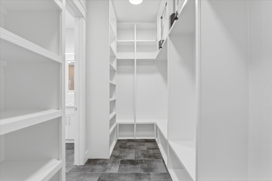 11626 Flintlock Road La Porte, TX 77571 - Photo 13 of 26 The primary closet offers extensive shelving and convenient pull-down rods for efficient use of space.