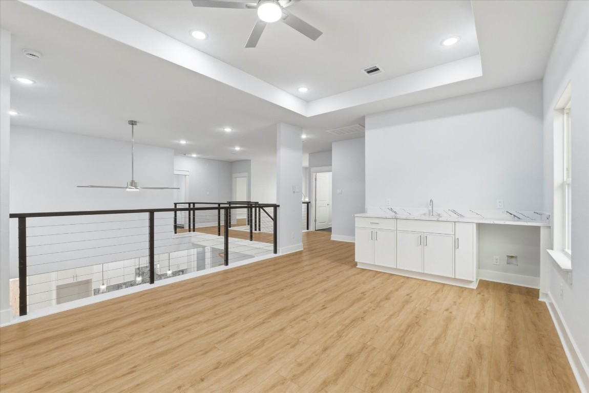 11626 Flintlock Road La Porte, TX 77571 - Photo 16 of 26 The spacious game room overlooks the main living area and features a sink, additional cabinet storage, and a designated space for a beverage refrigerator.