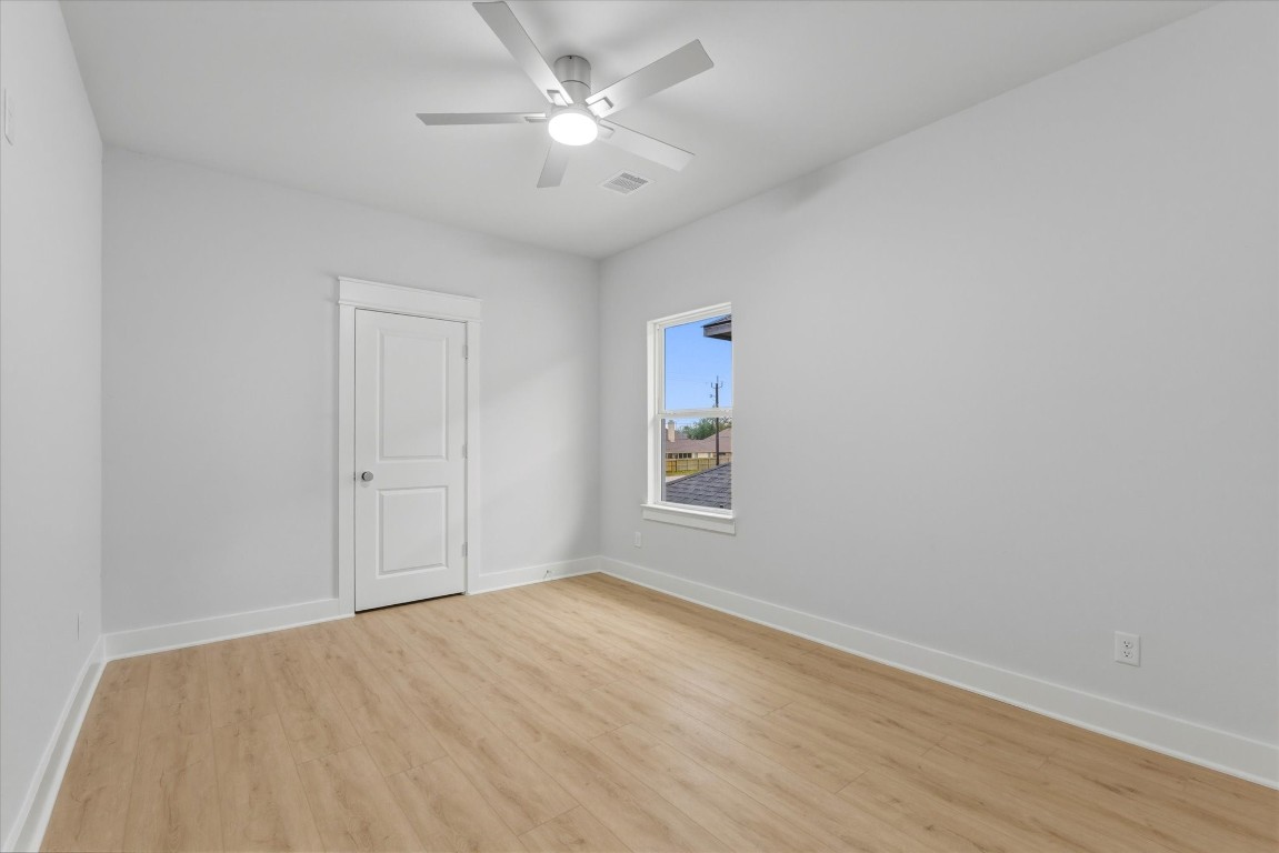 11626 Flintlock Road La Porte, TX 77571 - Photo 19 of 26 a view of empty room with wooden floor and fan