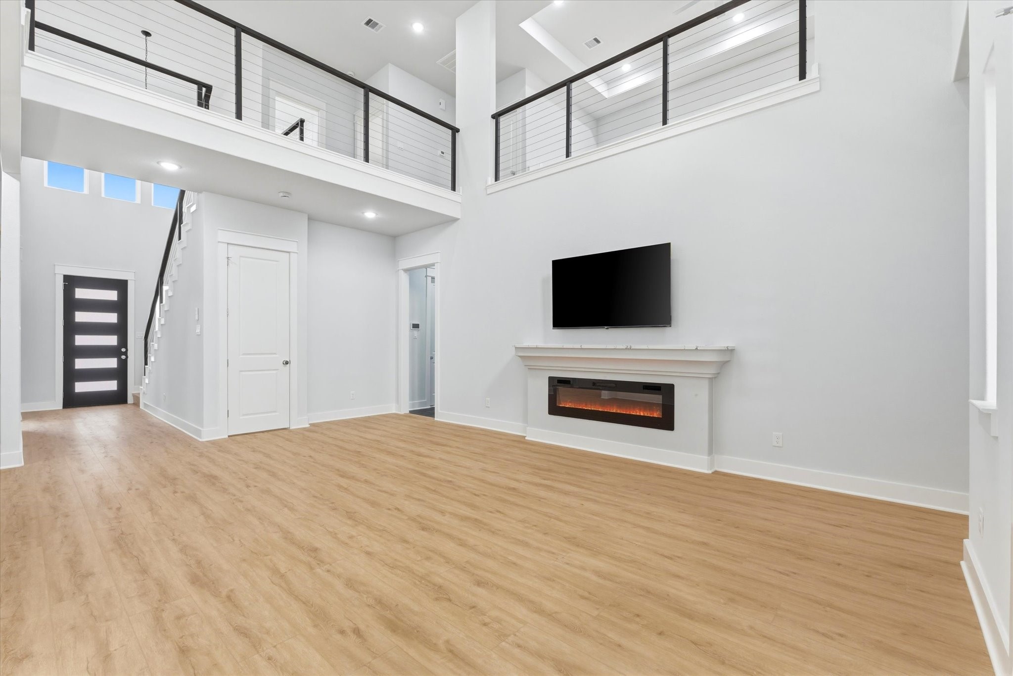 11626 Flintlock Road La Porte, TX 77571 - Photo 4 of 26 a view of a livingroom with a fireplace a flat screen tv and staircase
