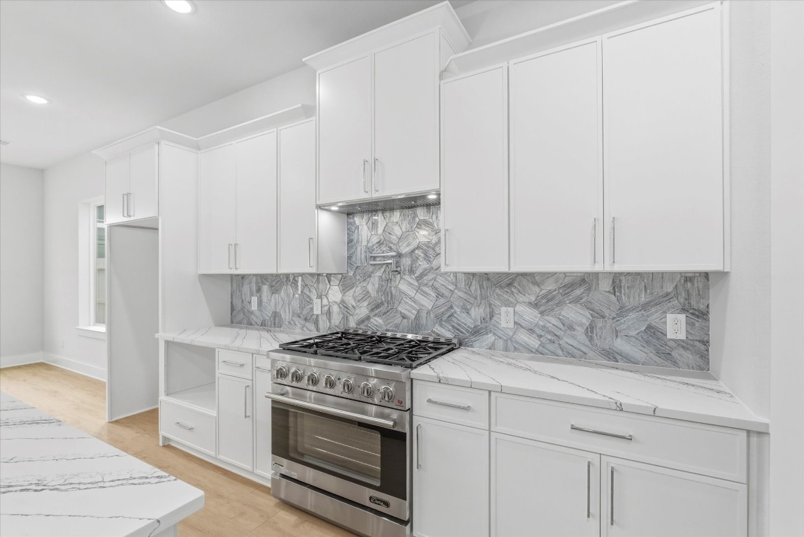 11626 Flintlock Road La Porte, TX 77571 - Photo 5 of 26 a kitchen with stainless steel appliances granite countertop white cabinets and a stove