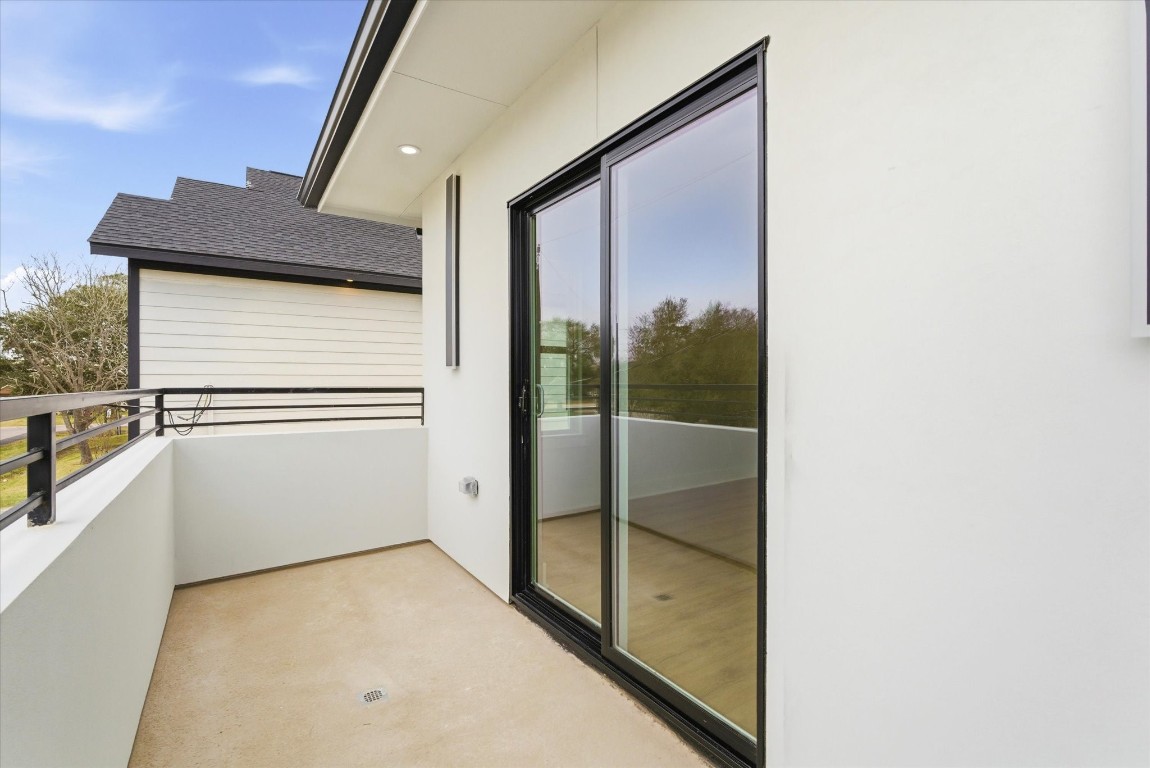 11626 Flintlock Road La Porte, TX 77571 - Photo 7 of 26 One of the upstairs bedrooms features a private balcony, a rare and desirable feature.