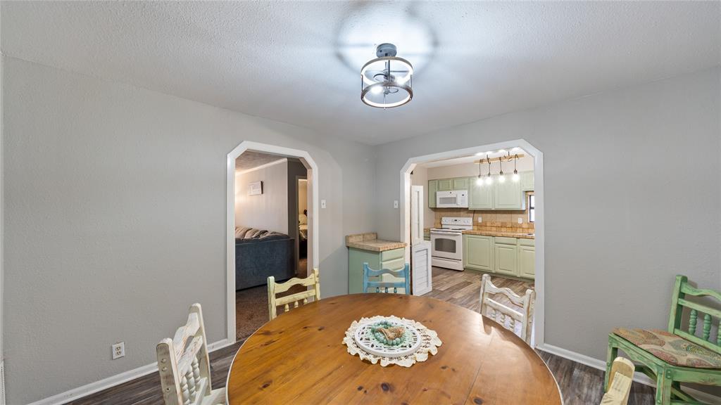 14260 North 3rd Street Scurry, TX 75158 - Photo 4 of 13 Dining room featuring arched walkways and light wood-type flooring
