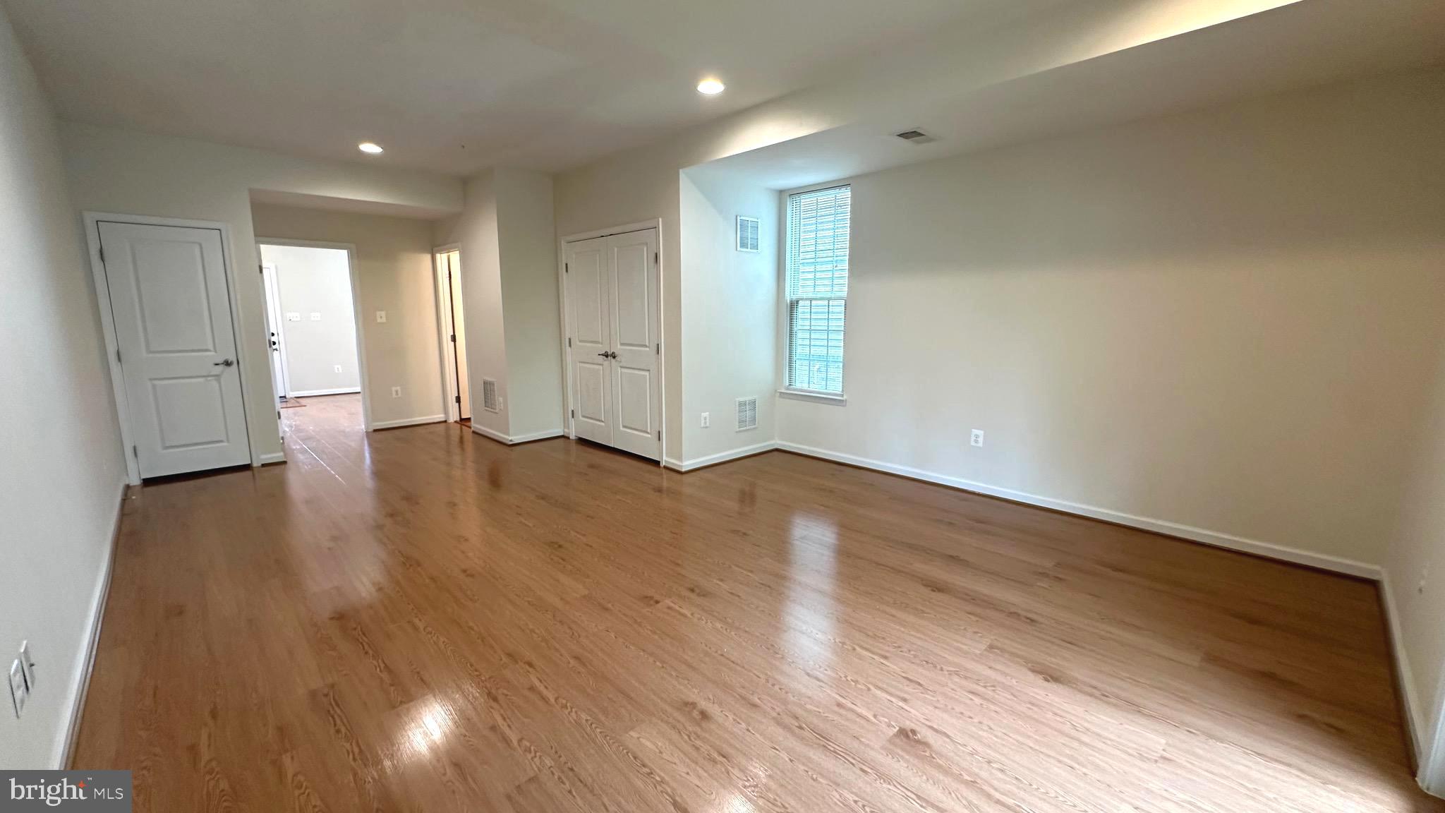7343 Old Calvary Road Hanover, MD 21076 - Photo 8 of 35 a view of an empty room with wooden floor and a window