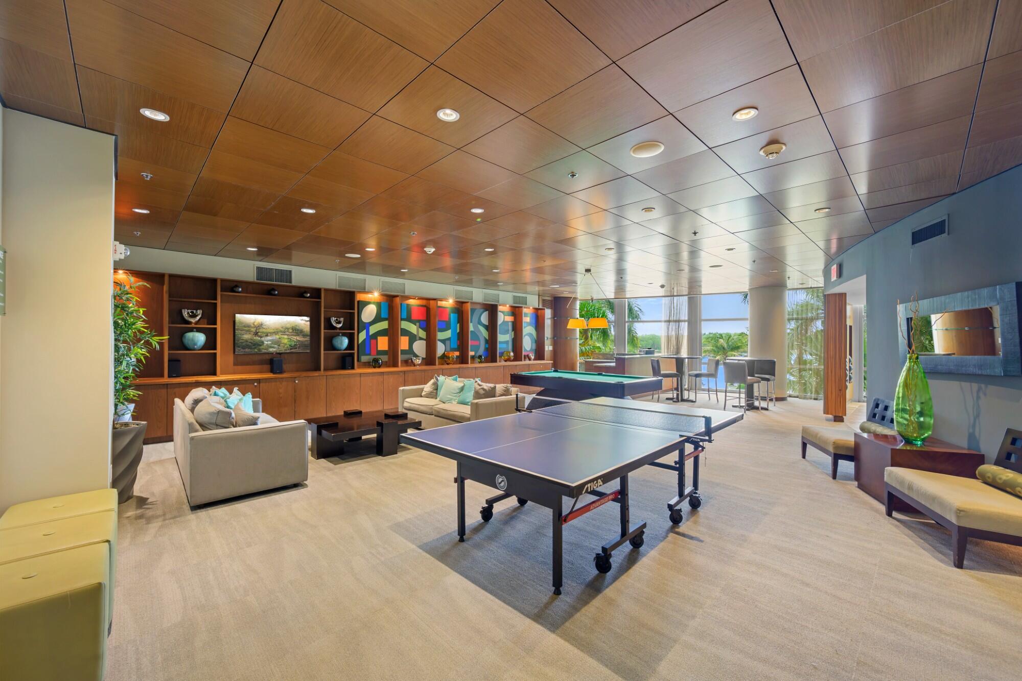 2641 North Flamingo Road, Unit 2108N Sunrise, FL 33323 - Photo 13 of 52 a living room with furniture a table and a potted plant