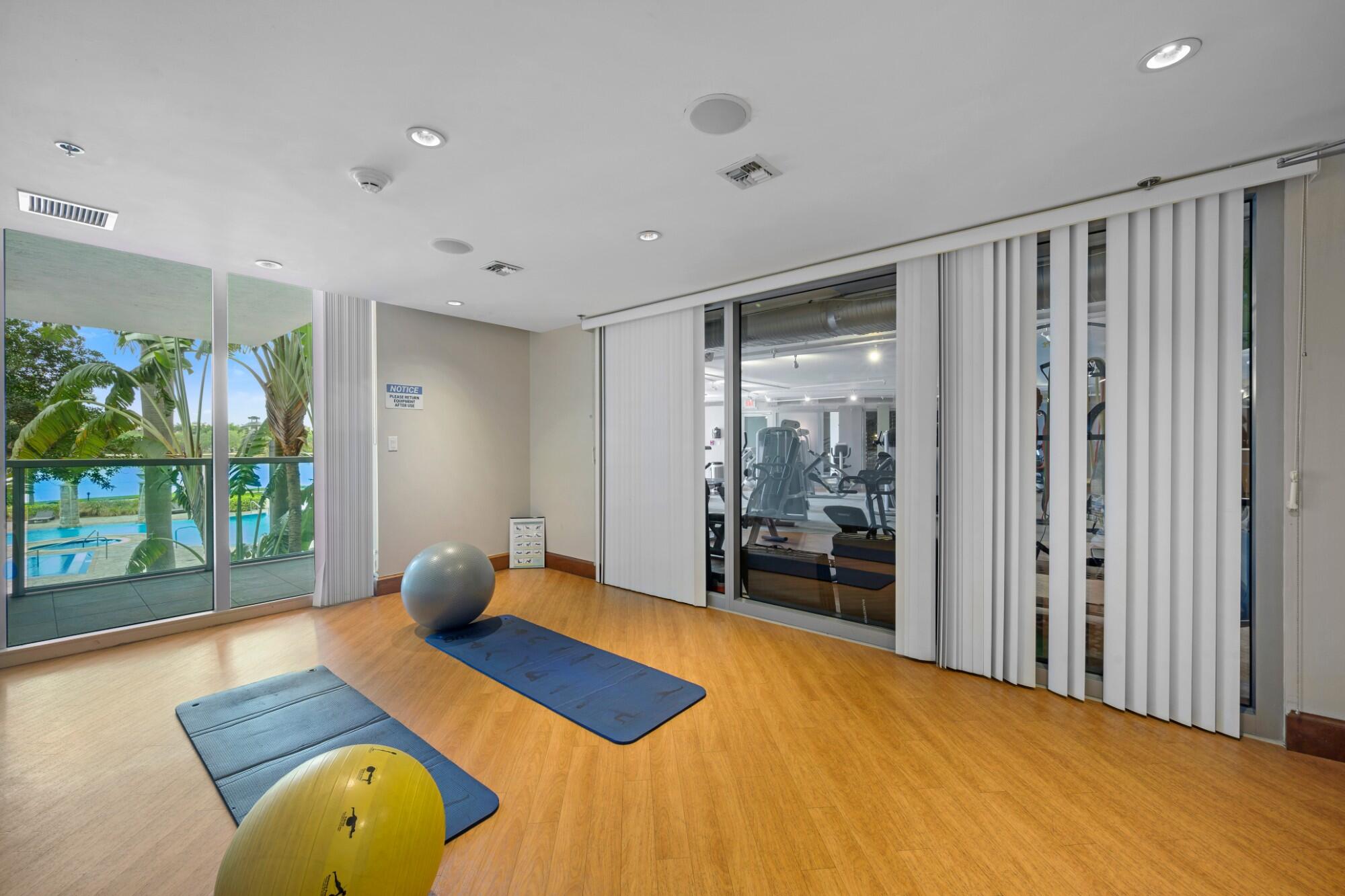 2641 North Flamingo Road, Unit 2108N Sunrise, FL 33323 - Photo 17 of 52 a bedroom with a bed and large windows