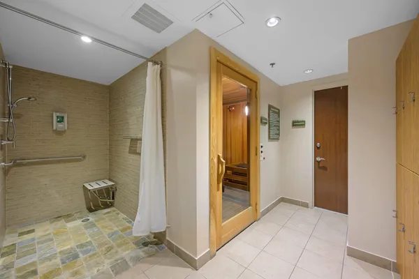 a view of a hallway with closet and bathroom