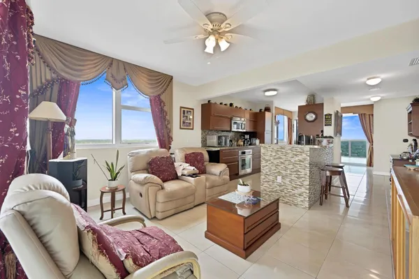 a living room with furniture a fireplace and a chandelier