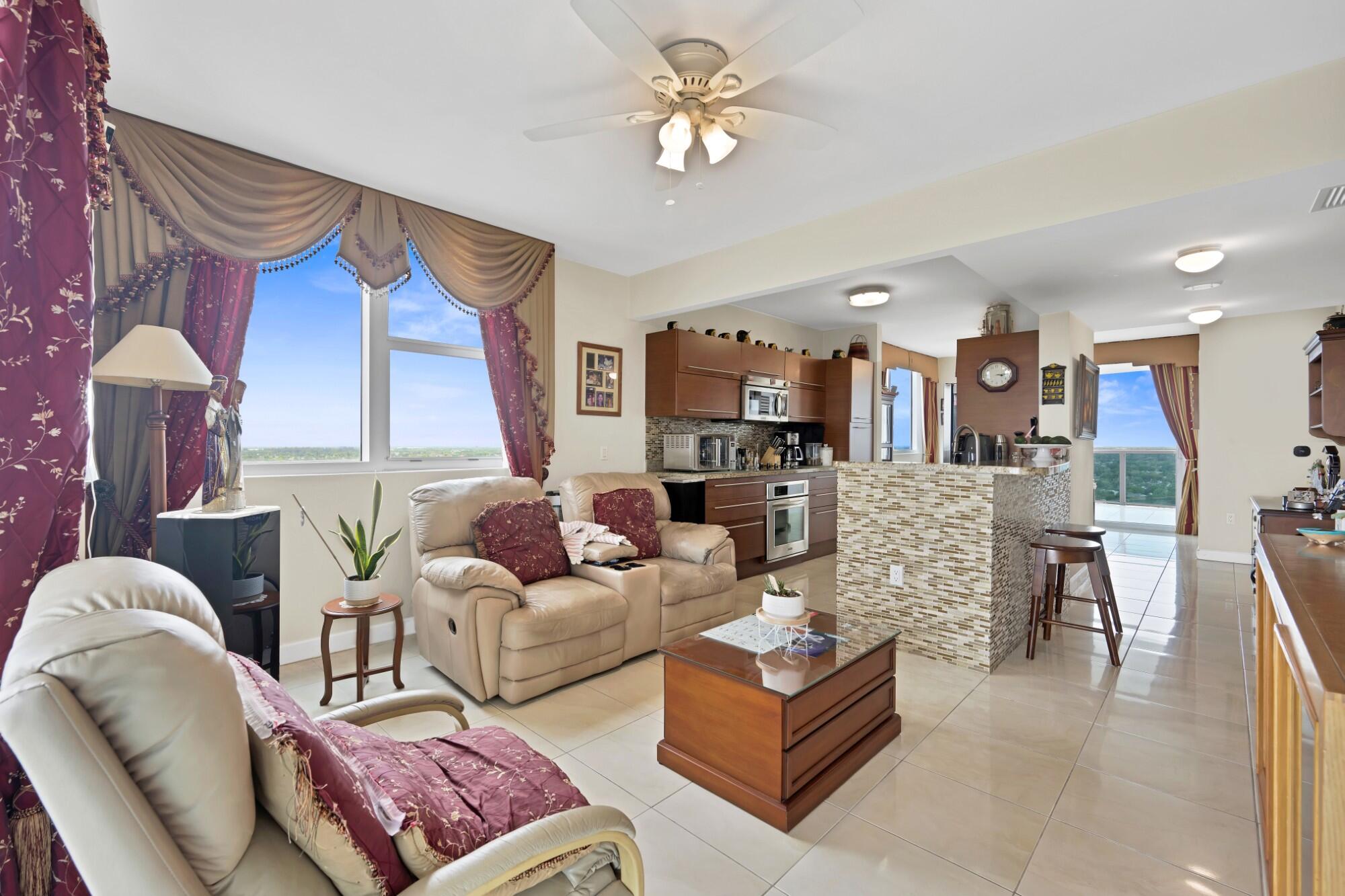 2641 North Flamingo Road, Unit 2108N Sunrise, FL 33323 - Photo 23 of 52 a living room with furniture a fireplace and a chandelier