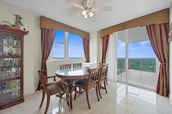 a dining room with furniture a chandelier and window