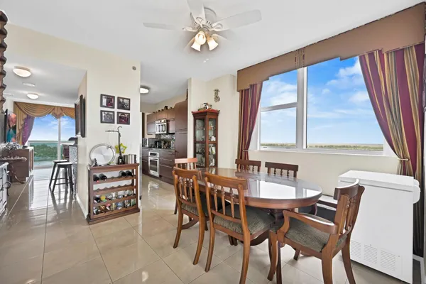 a view of a dining room with furniture and a large window