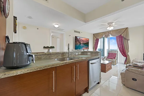 a bathroom with a granite countertop sink and a large mirror