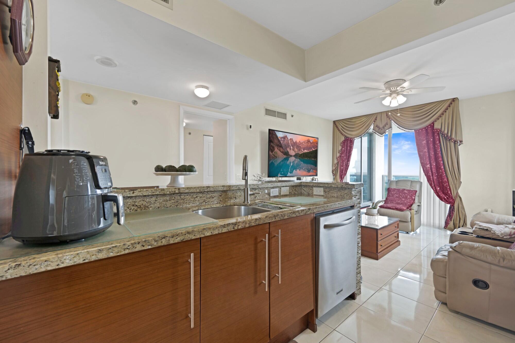 2641 North Flamingo Road, Unit 2108N Sunrise, FL 33323 - Photo 28 of 52 a bathroom with a granite countertop sink and a large mirror