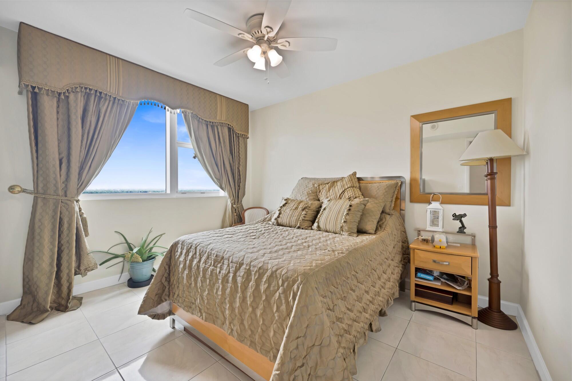 2641 North Flamingo Road, Unit 2108N Sunrise, FL 33323 - Photo 35 of 52 a bedroom with a bed and a chandelier