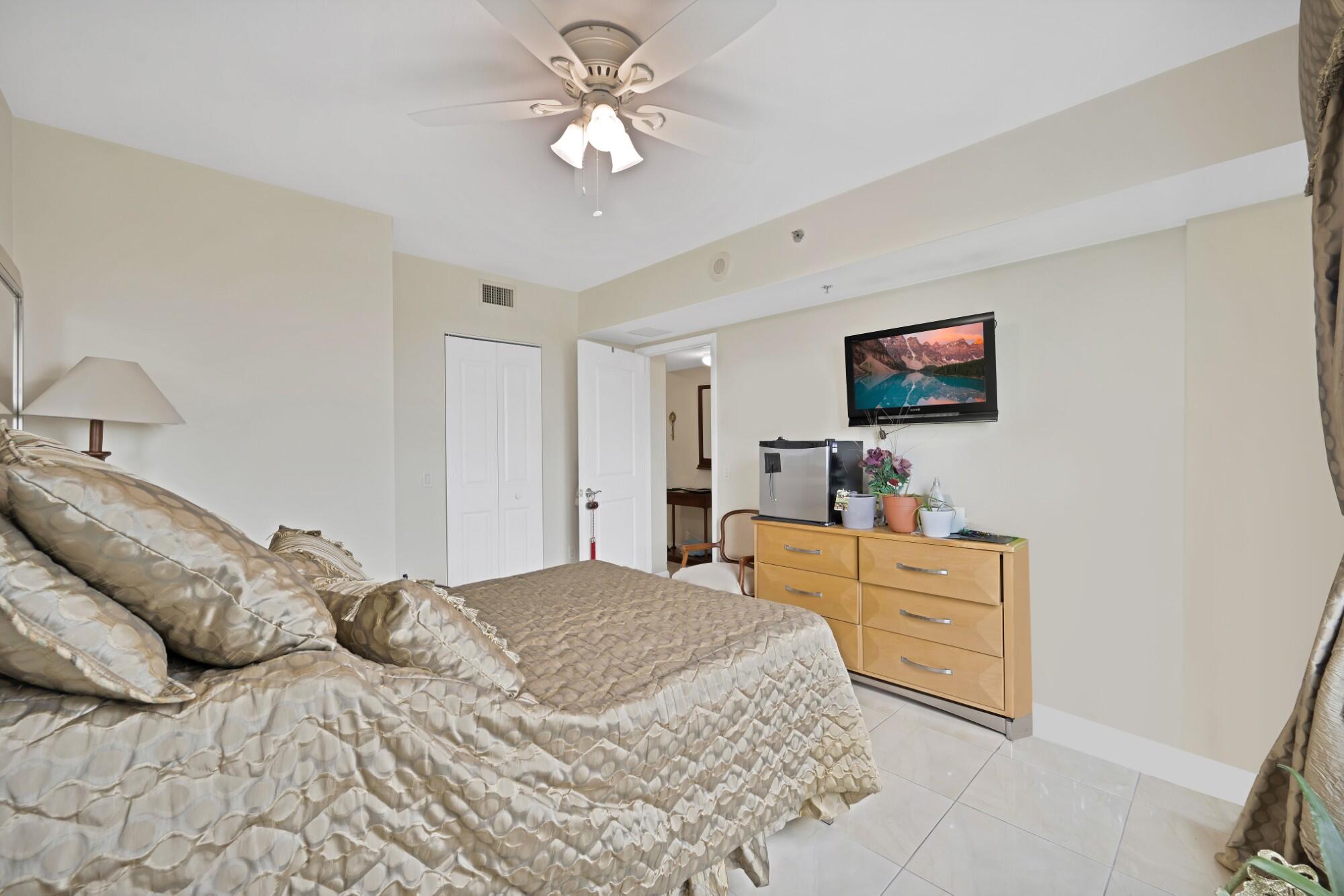 2641 North Flamingo Road, Unit 2108N Sunrise, FL 33323 - Photo 36 of 52 a bedroom with a bed and a flat screen tv