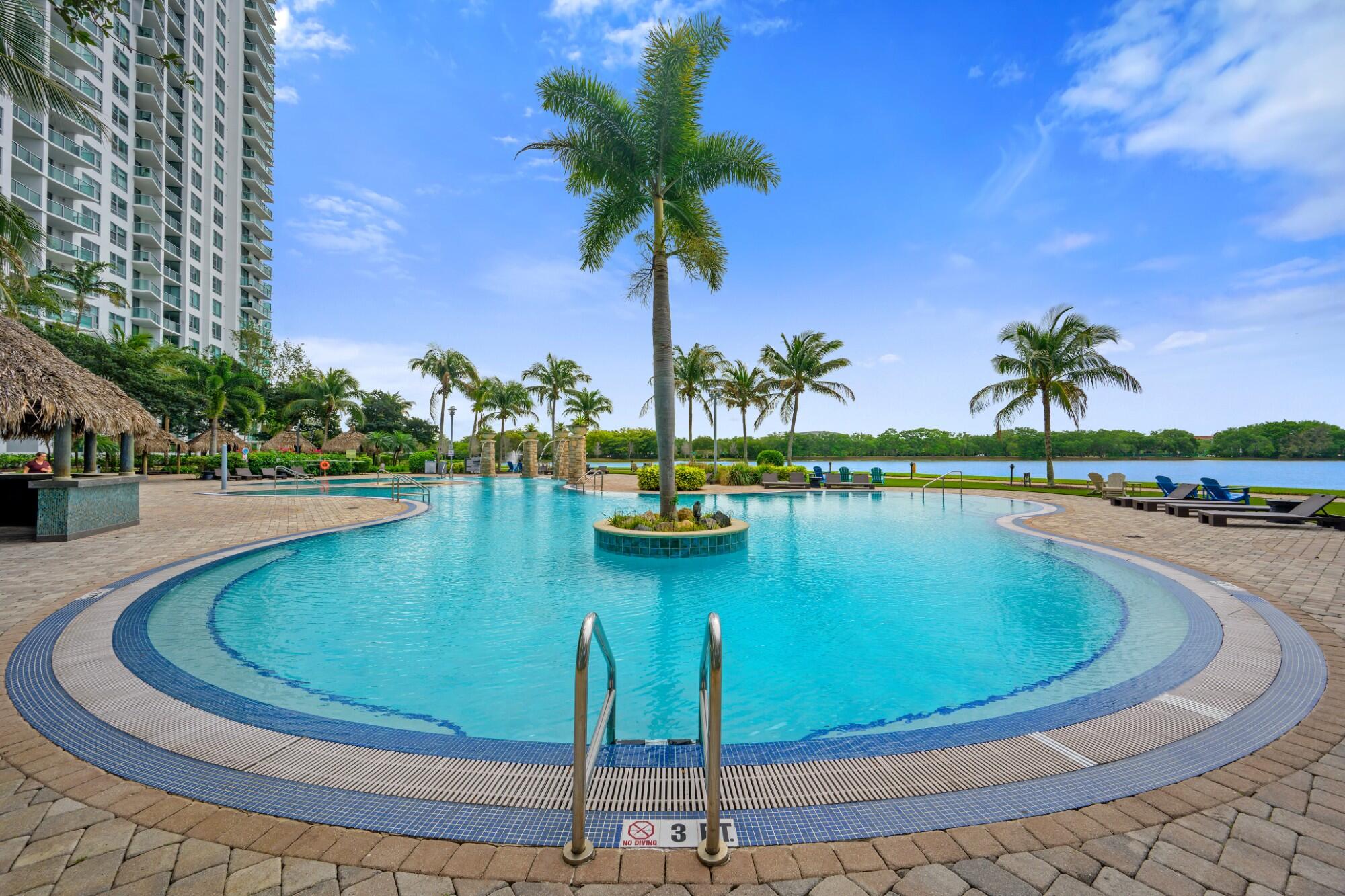 2641 North Flamingo Road, Unit 2108N Sunrise, FL 33323 - Photo 8 of 52 a view of a swimming pool with a table and chairs