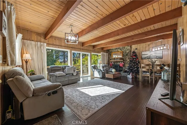 a living room with patio a couch and a flat screen tv