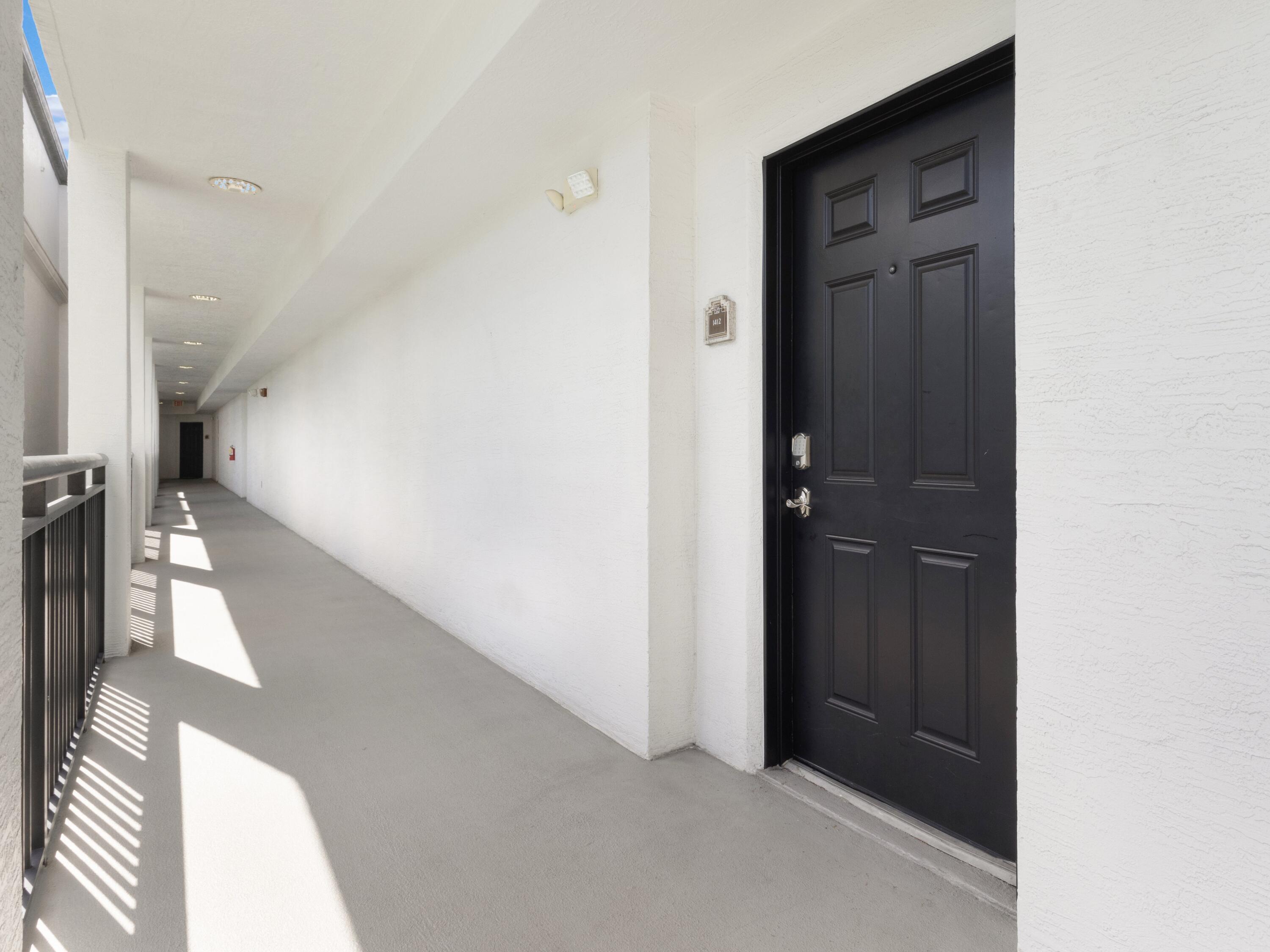 1690 Renaissance Commons Boulevard, Unit 1412 Boynton Beach, FL 33426 - Photo 1 of 49 a view of a hallway with a white walls