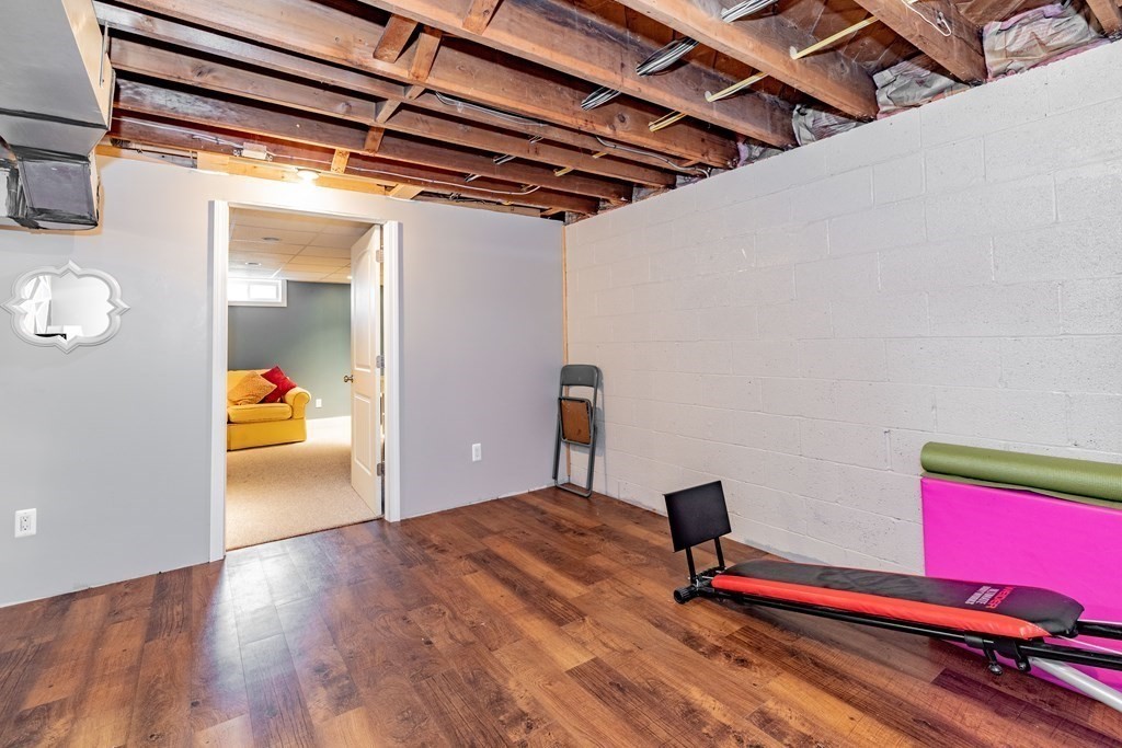 65 Mountain Road Holyoke, MA 01040 - Photo 24 of 35 a bedroom with a bed and wooden floor