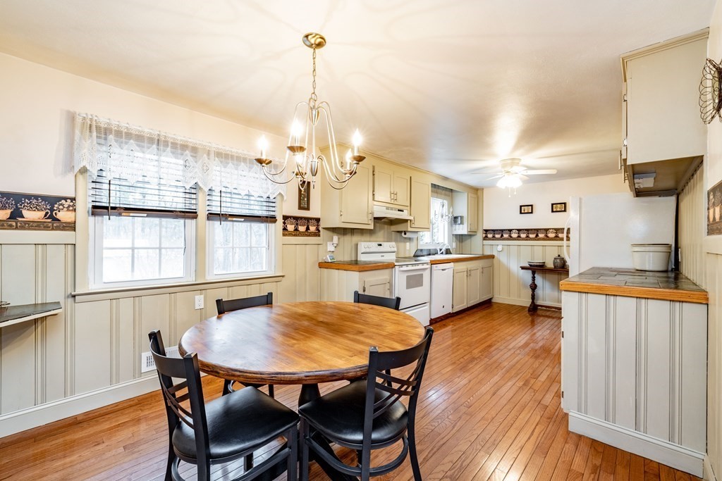 65 Mountain Road Holyoke, MA 01040 - Photo 7 of 35 a kitchen with stainless steel appliances kitchen island granite countertop a table chairs and a refrigerator