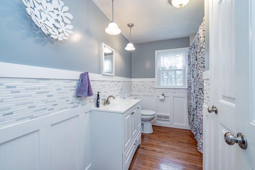 65 Mountain Road Holyoke, MA 01040 - Photo 9 of 35 a bathroom with a sink a toilet a mirror and shower