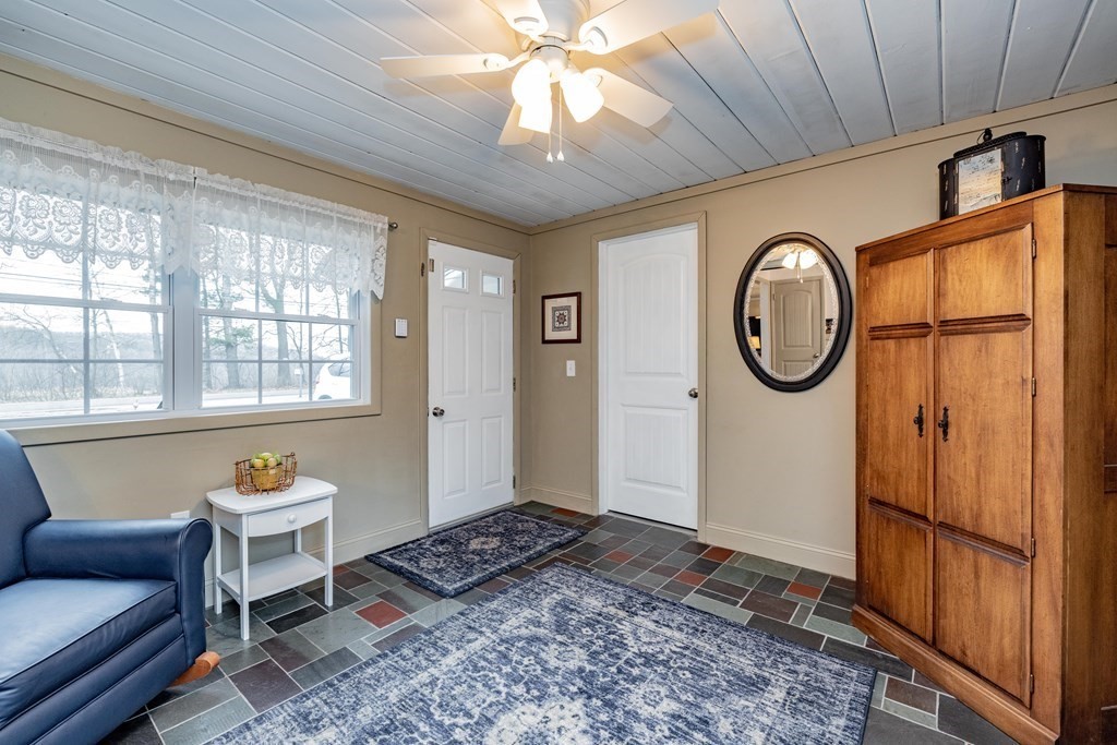 65 Mountain Road Holyoke, MA 01040 - Photo 10 of 35 a living room with furniture a window and a chandelier