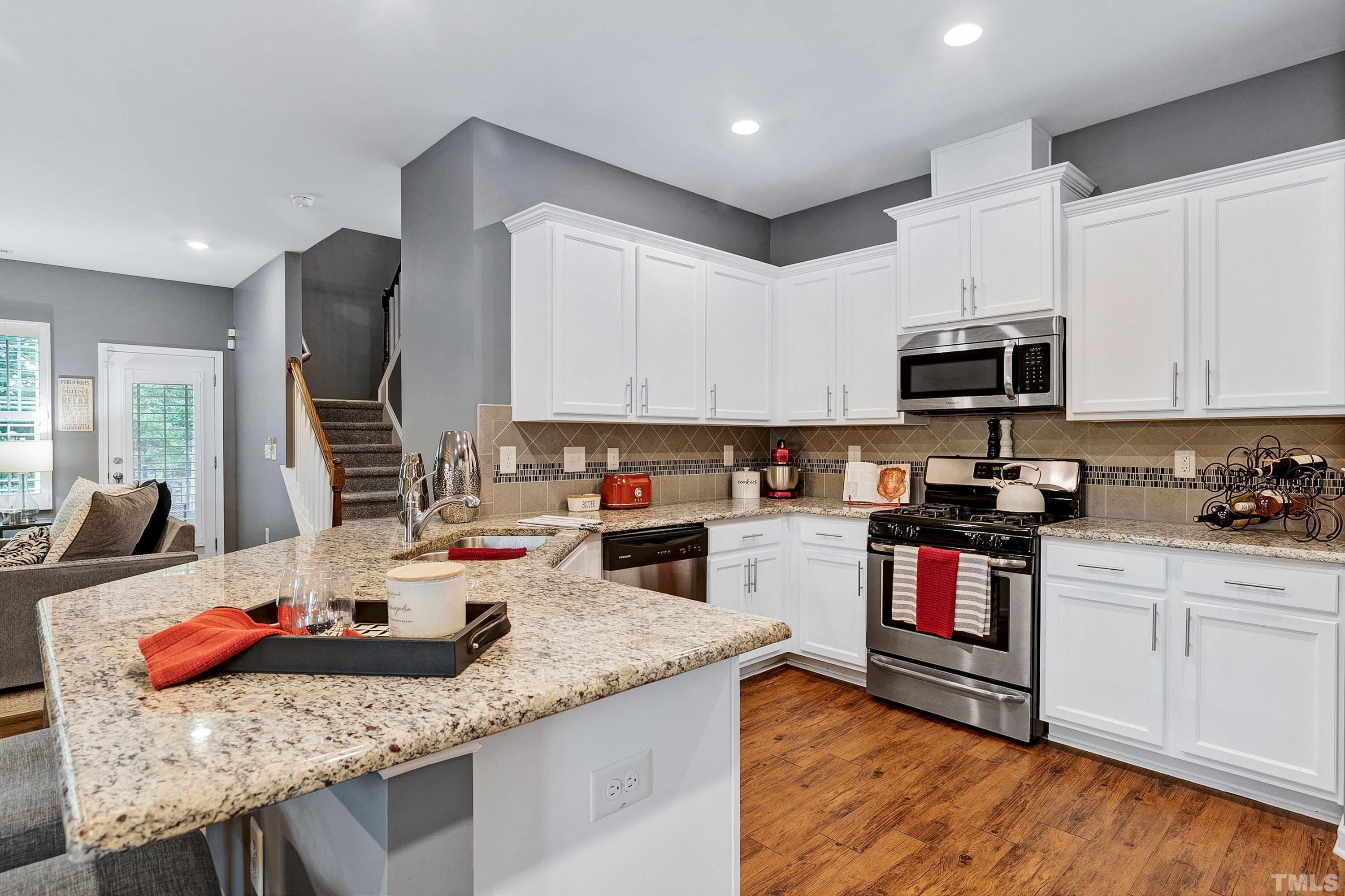 1161 Lookout Ridge Road Apex, NC 27502 - Photo 14 of 36 a kitchen with granite countertop stainless steel appliances and wooden cabinets