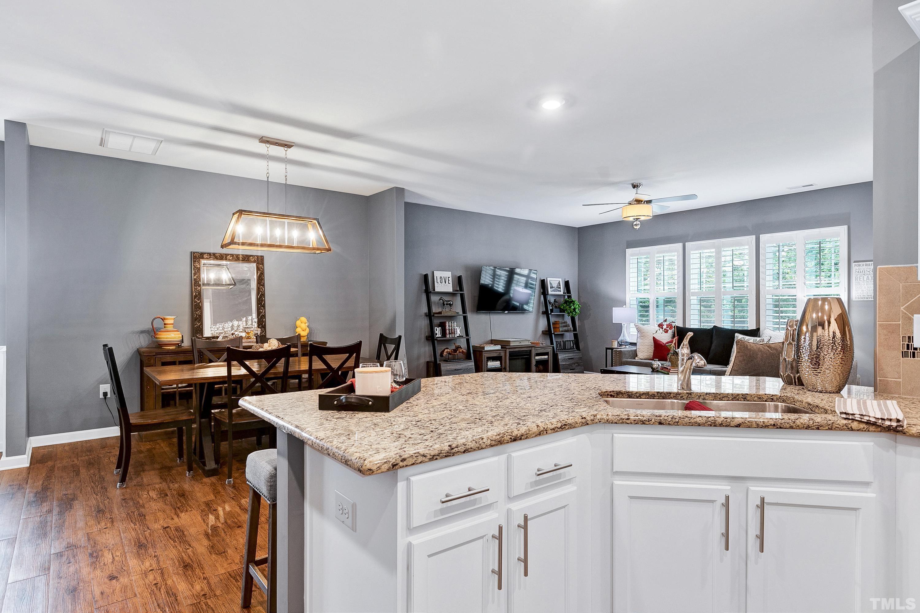 1161 Lookout Ridge Road Apex, NC 27502 - Photo 16 of 36 a kitchen with granite countertop sink dining table and chairs
