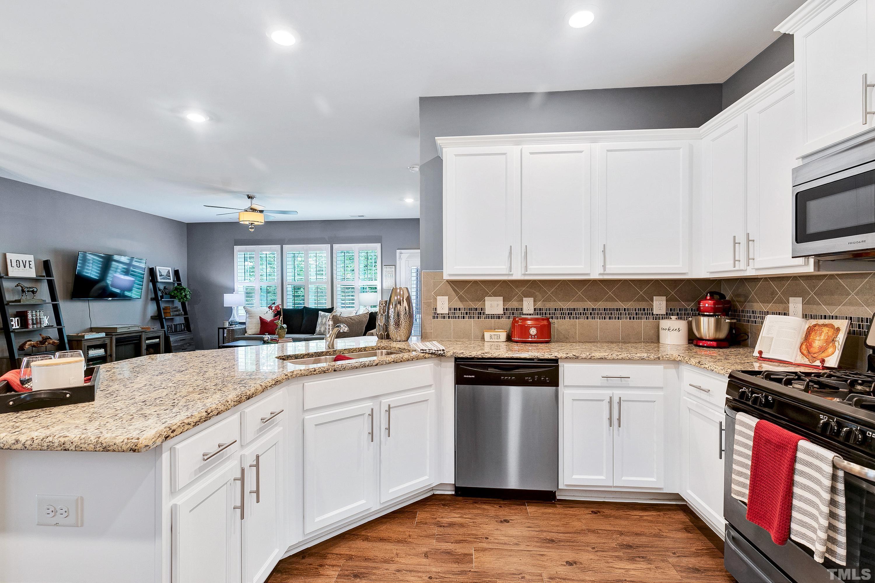 1161 Lookout Ridge Road Apex, NC 27502 - Photo 17 of 36 a kitchen with stainless steel appliances granite countertop a stove sink and cabinets