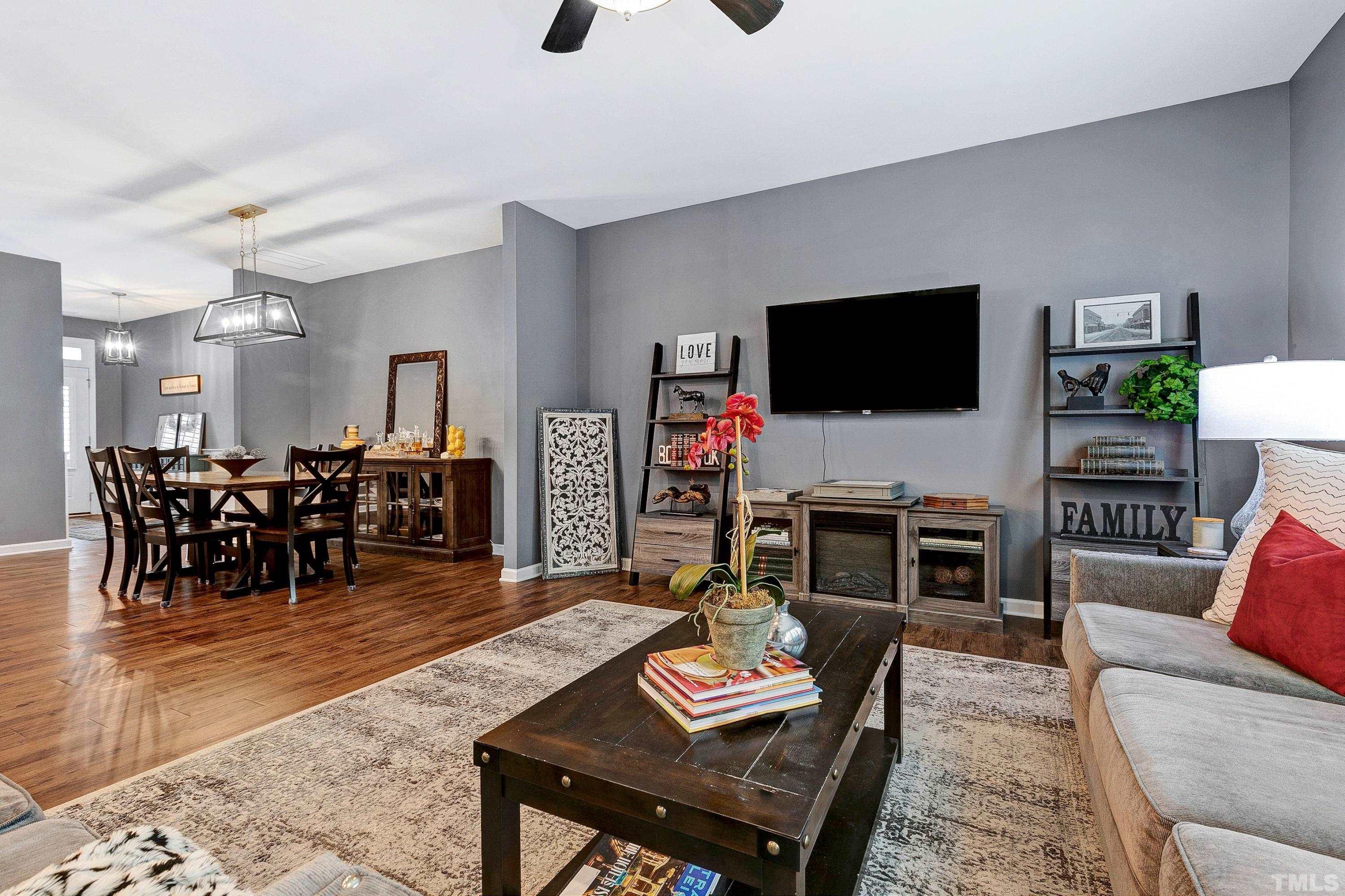 1161 Lookout Ridge Road Apex, NC 27502 - Photo 18 of 36 a living room with furniture and a flat screen tv with kitchen view