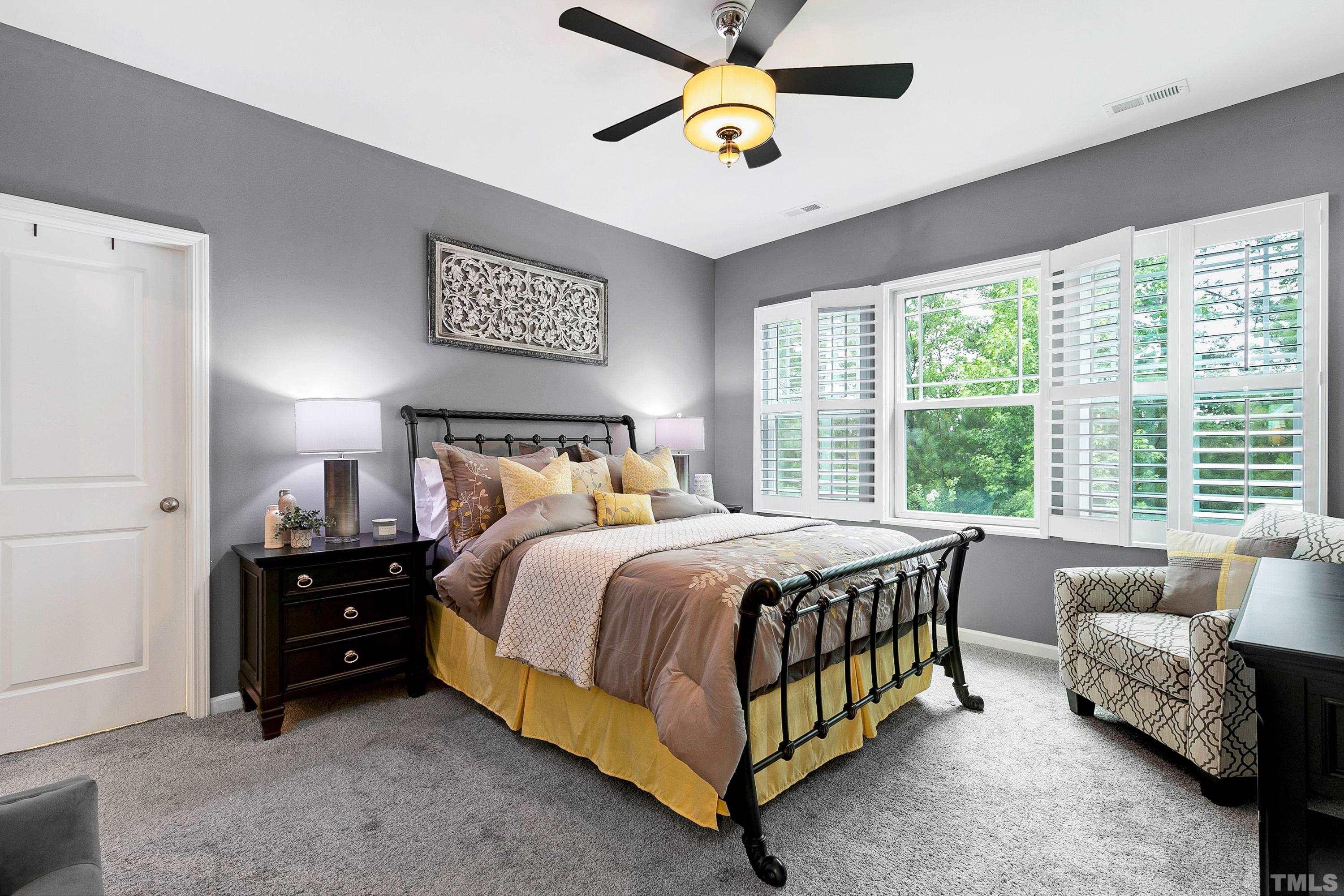 1161 Lookout Ridge Road Apex, NC 27502 - Photo 24 of 36 a bedroom with a bed and a couch