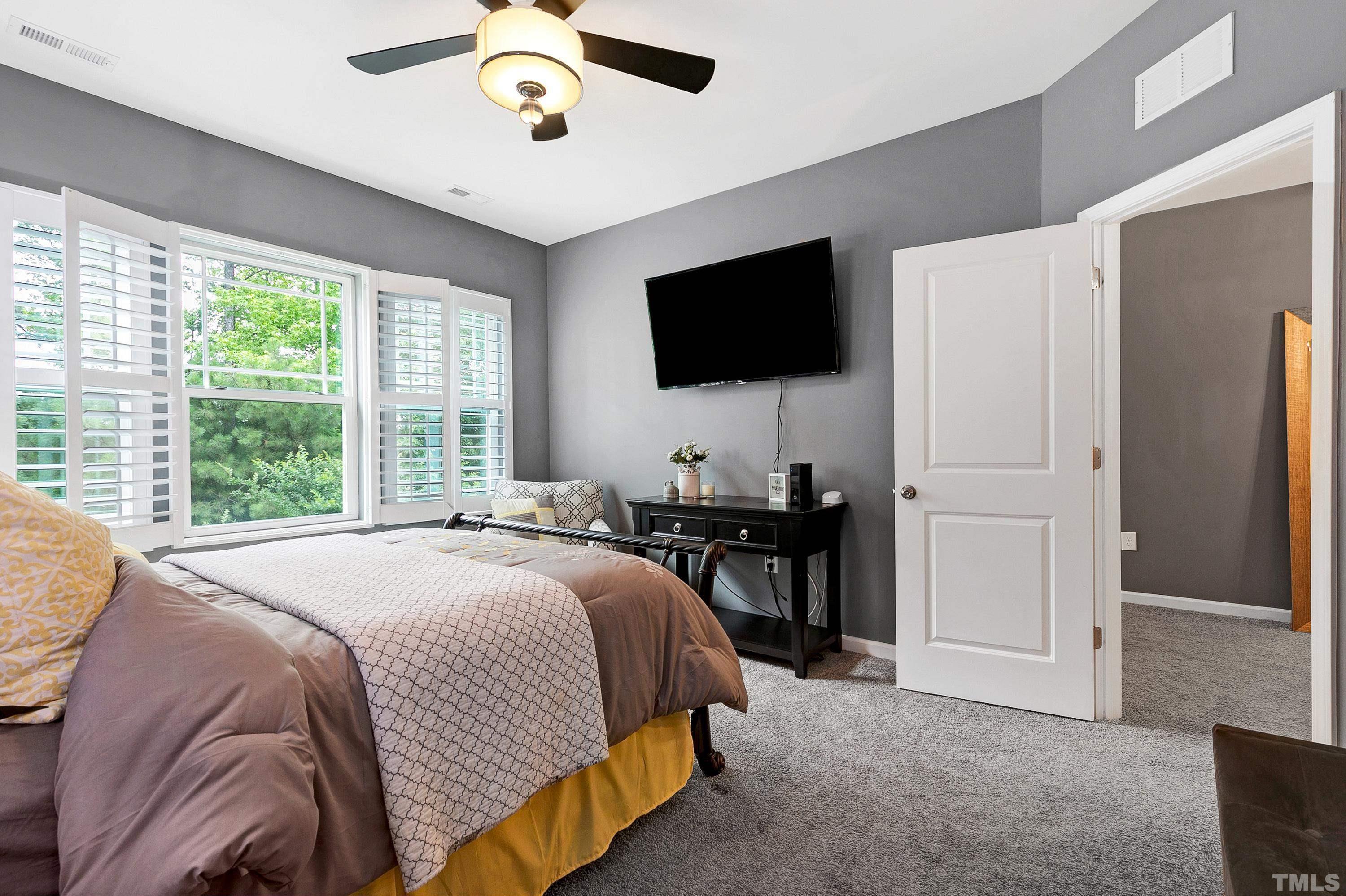 1161 Lookout Ridge Road Apex, NC 27502 - Photo 25 of 36 a bedroom with a bed and a flat screen tv