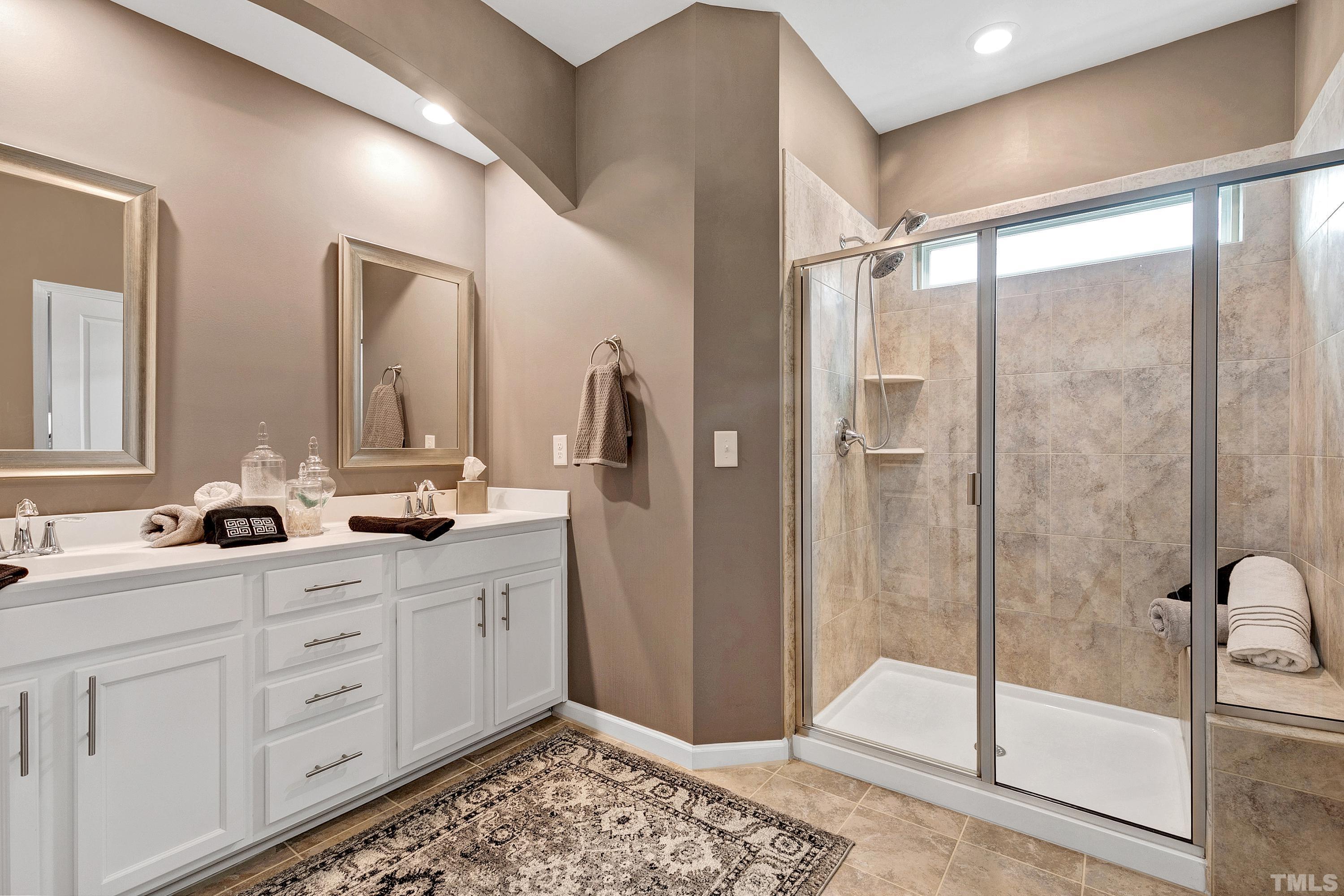1161 Lookout Ridge Road Apex, NC 27502 - Photo 27 of 36 a bathroom with a double vanity sink mirror and shower