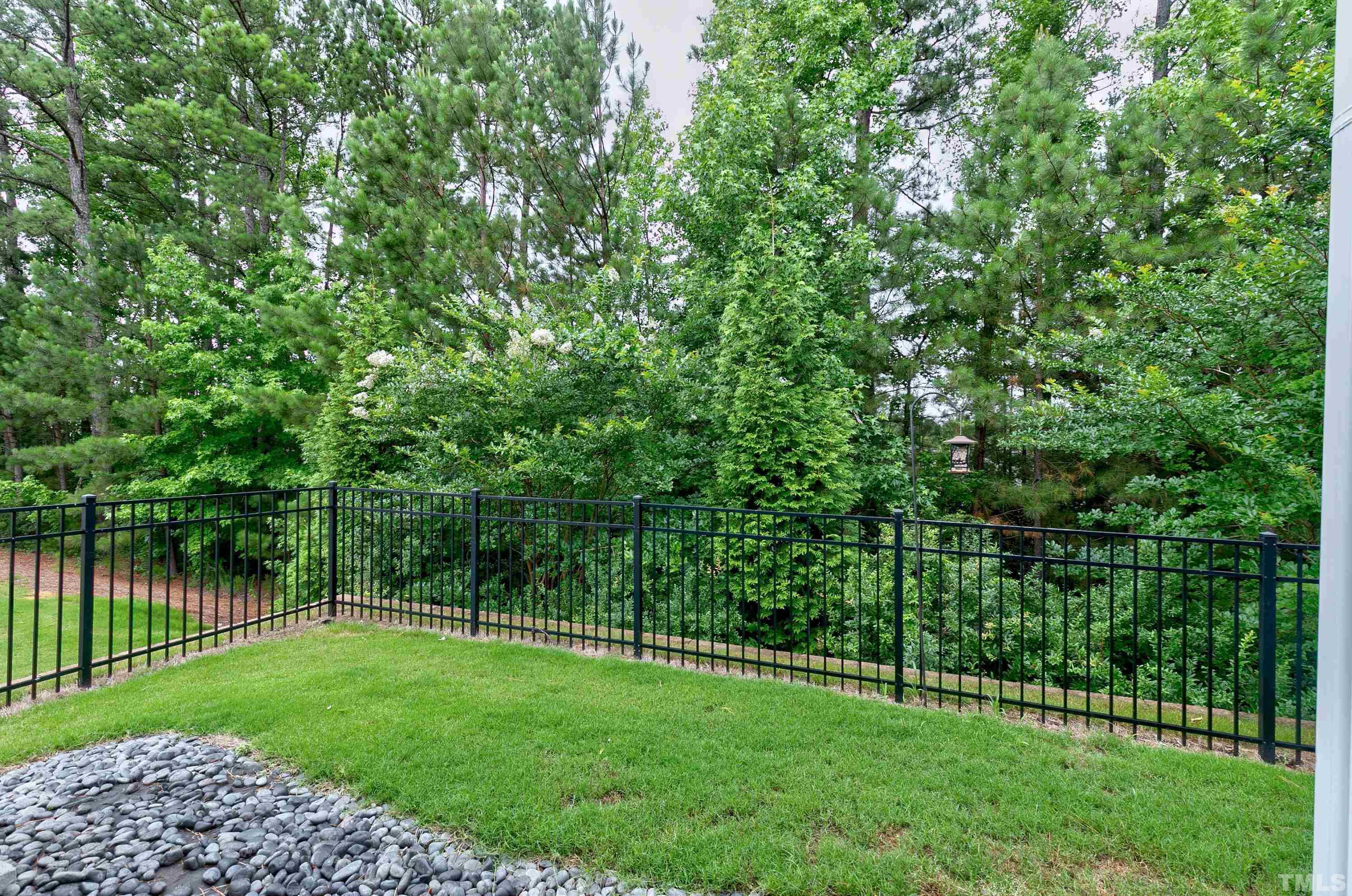 1161 Lookout Ridge Road Apex, NC 27502 - Photo 35 of 36 a view of a green field with wooden fence