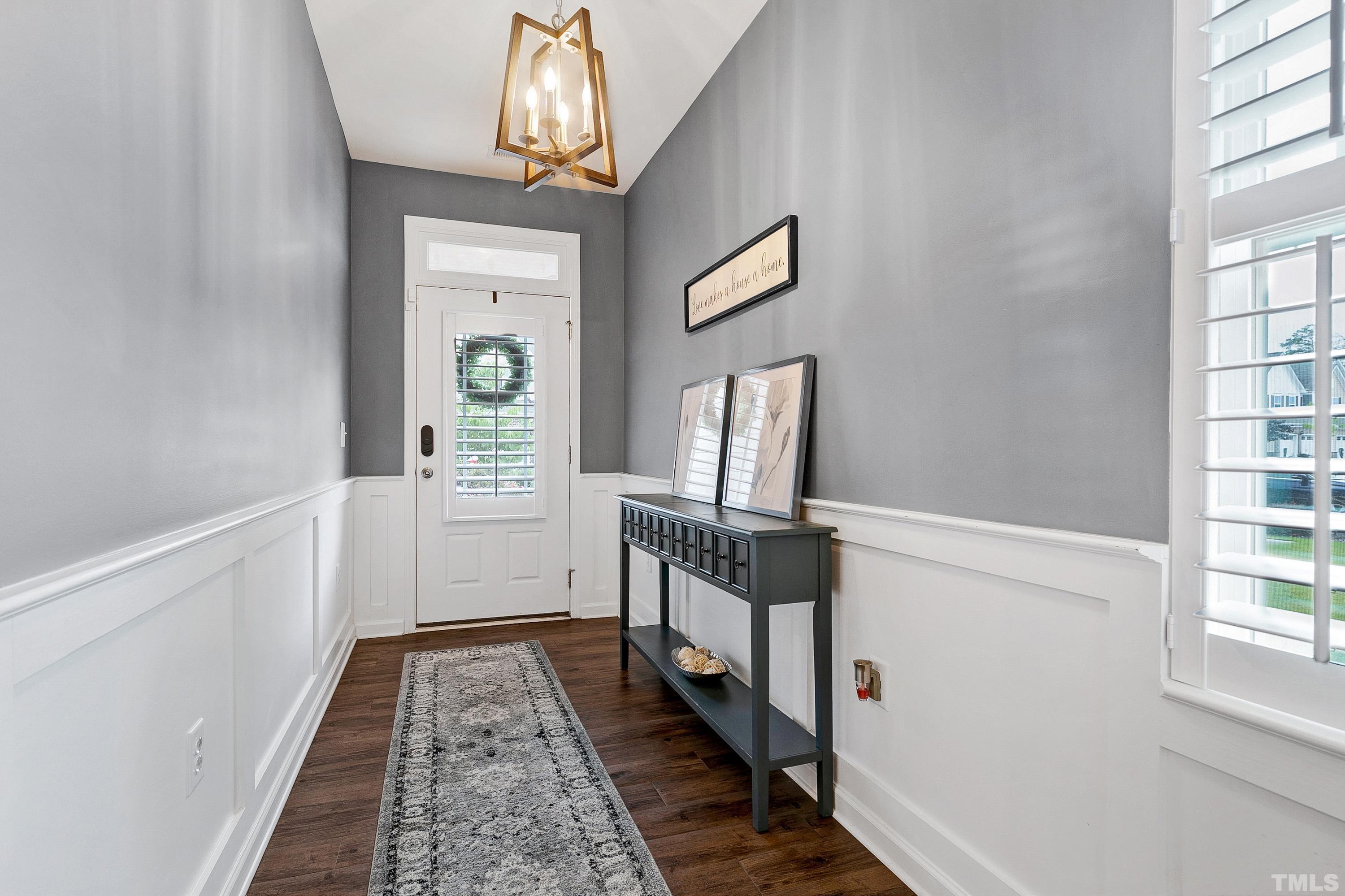 1161 Lookout Ridge Road Apex, NC 27502 - Photo 5 of 36 a hallway with wooden floor chandelier and entryway