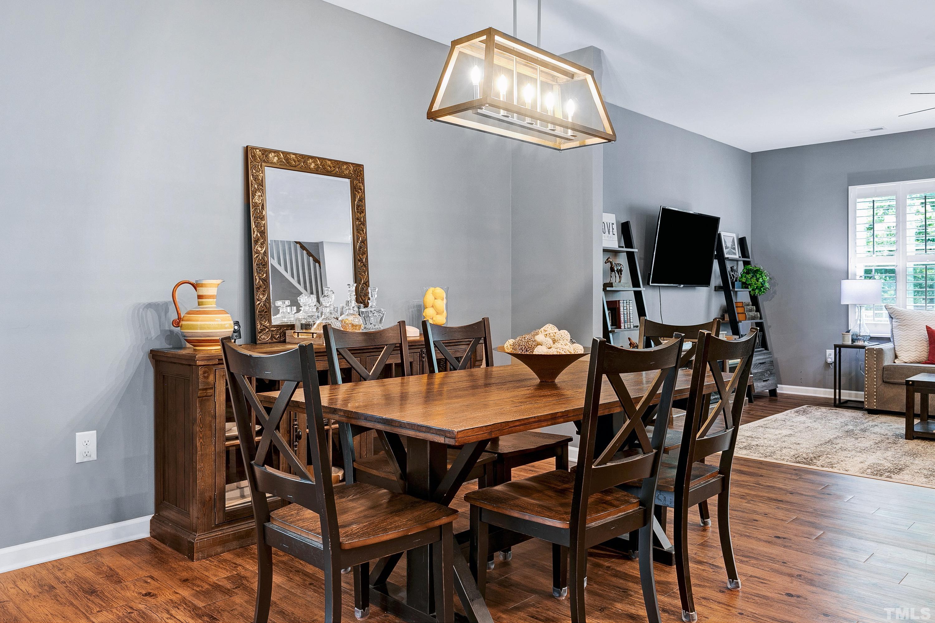 1161 Lookout Ridge Road Apex, NC 27502 - Photo 7 of 36 a view of a dining room with furniture and wooden floor