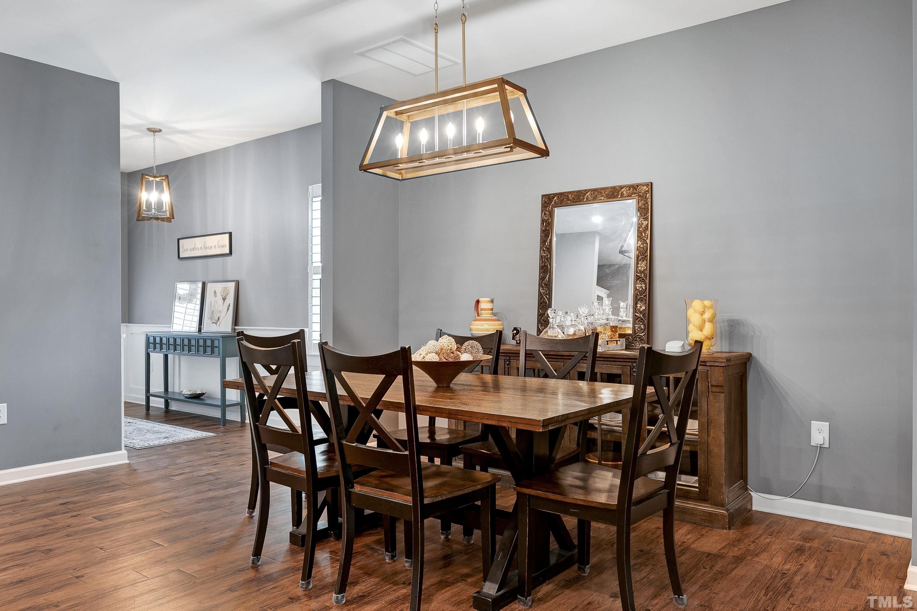 1161 Lookout Ridge Road Apex, NC 27502 - Photo 8 of 36 a view of a dining room with furniture and wooden floor