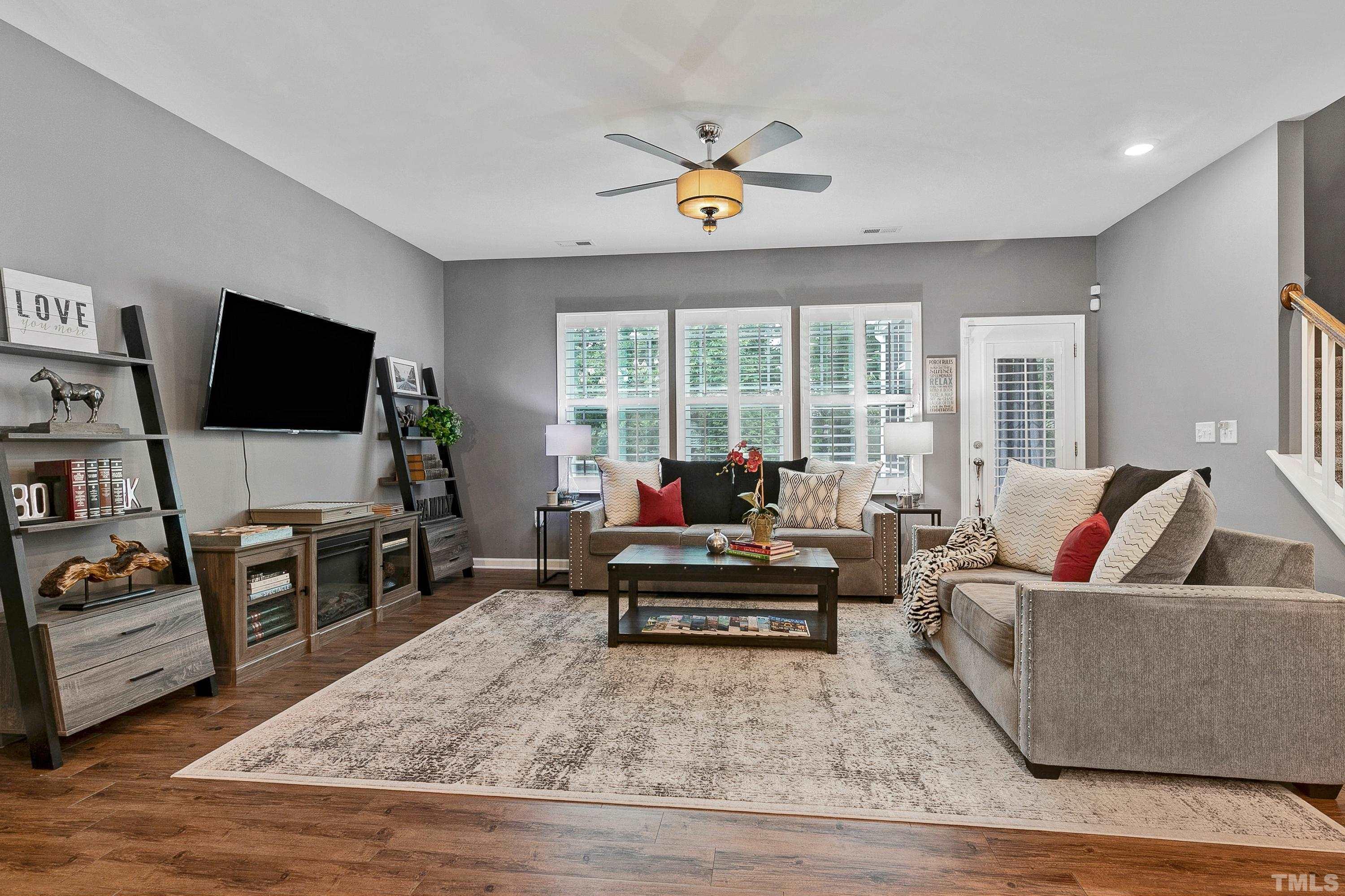 1161 Lookout Ridge Road Apex, NC 27502 - Photo 9 of 36 a living room with furniture and a flat screen tv