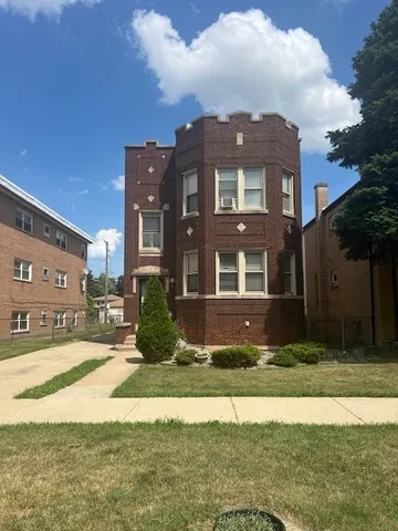 a view of house with yard in front of it