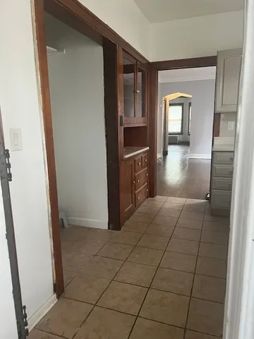 an empty room with wooden floor and door