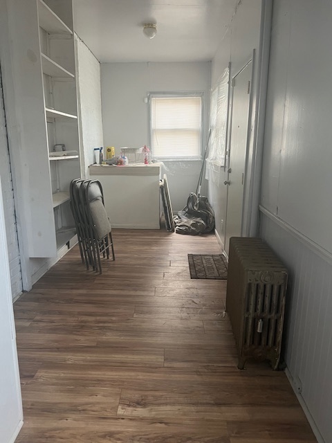 9735 South Michigan Avenue, Unit 1 Chicago, IL 60628 - Photo 15 of 17 a living room with furniture and a wooden floor