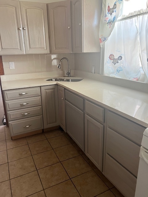 9735 South Michigan Avenue, Unit 1 Chicago, IL 60628 - Photo 3 of 17 a kitchen with appliances cabinets and a sink
