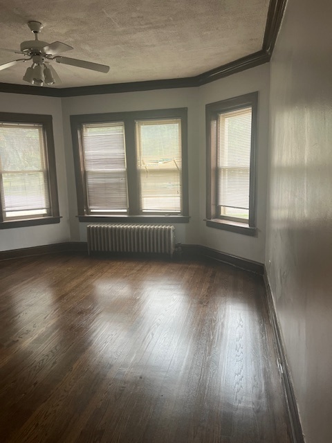 9735 South Michigan Avenue, Unit 1 Chicago, IL 60628 - Photo 6 of 17 an empty room with wooden floor and windows