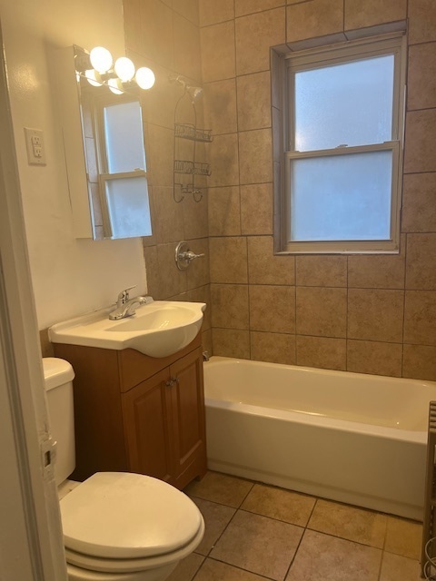 9735 South Michigan Avenue, Unit 1 Chicago, IL 60628 - Photo 9 of 17 a bathroom with a sink a toilet and shower