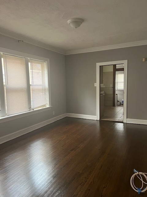 9735 South Michigan Avenue, Unit 1 Chicago, IL 60628 - Photo 10 of 17 a view of an empty room with wooden floor and a window