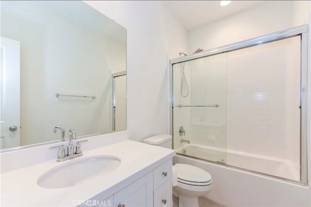 175 Frame Irvine, CA 92618 - Photo 17 of 22 a bathroom with a sink a mirror toilet and shower